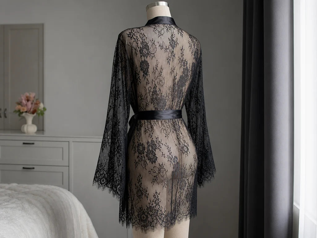 Professional garment drape study, 4:3. Show the exact sourced black floral lace robe from a rear thr